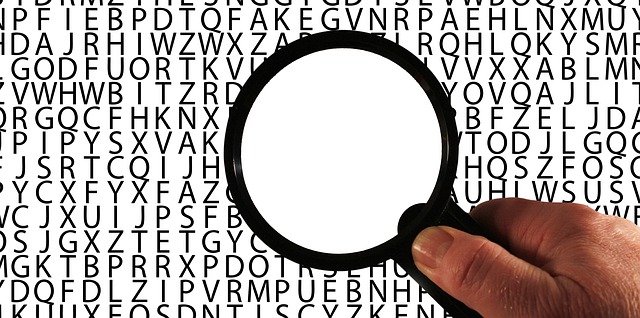 an opaque magnifying glass held over letters in the alphabet