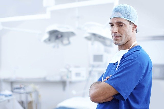dentist with his arms folded looking down