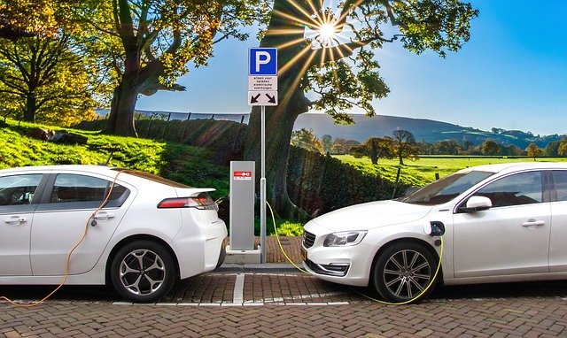 electric cars charging in parallel parking spots on a sunny day