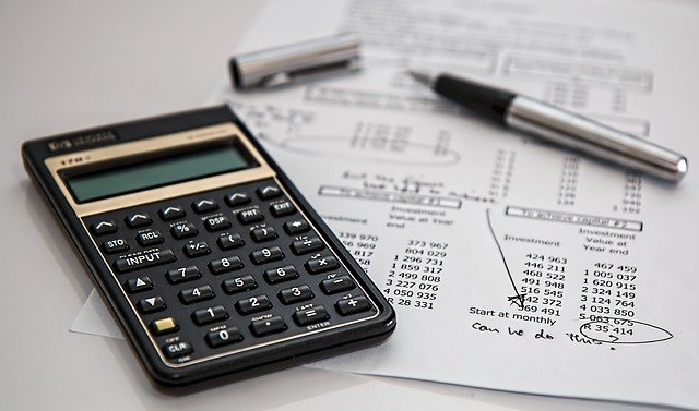 calculator resting on tax form with total to pay circled