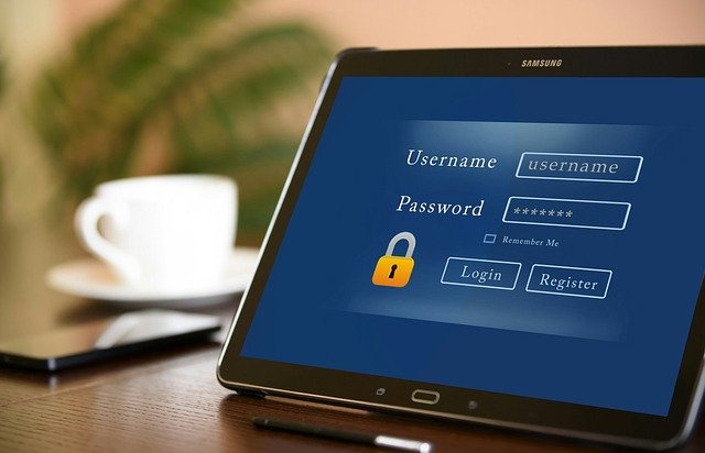 closeup of a login screen on a desk with a cup of coffee in the background