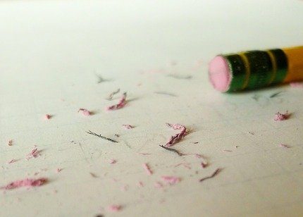 a pencil eraser shards on a white paper