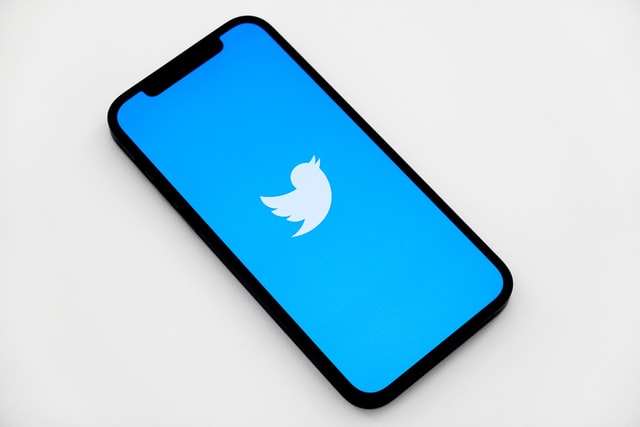 an iphone with the twitter app opening on the screen