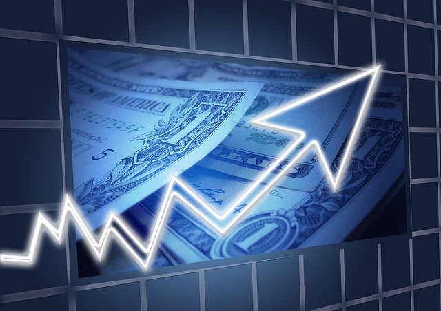 chart with an arrow going up and USD bills in the background