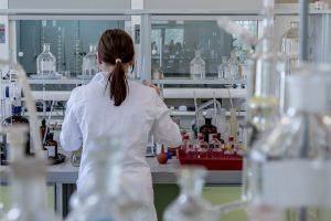 a doctor working in a lab their back facing us