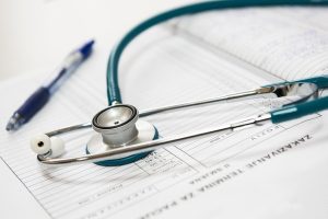 stethoscope resting on a financial statement