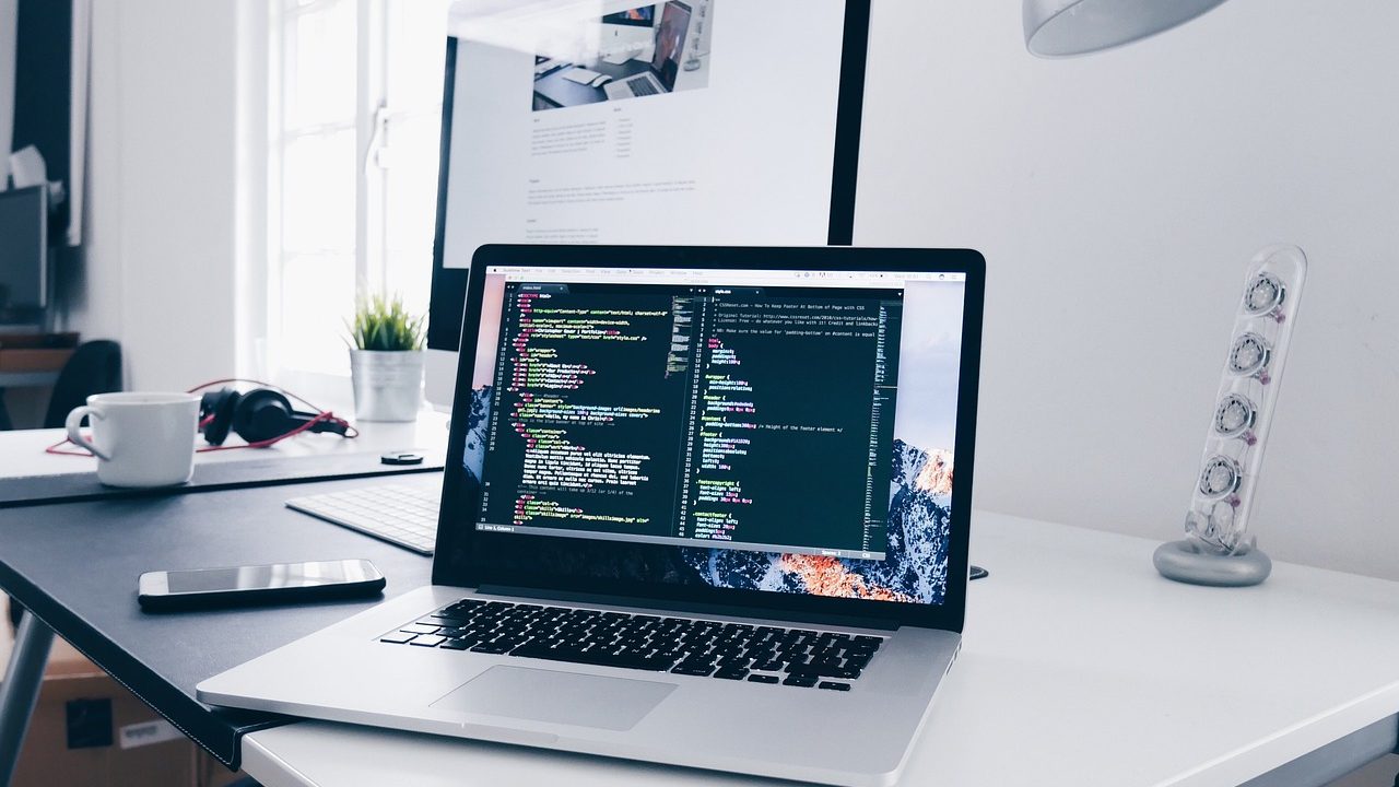 laptop on a desk with code on the screen