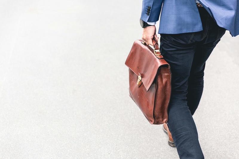 man walking with a briefcase from the torso down