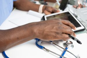 close up of nurse's hands on a tablet